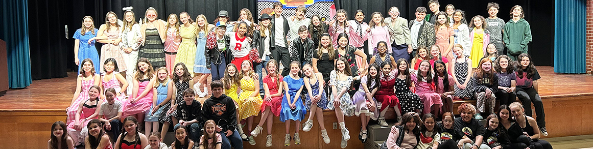 Cast of Grease on stage
