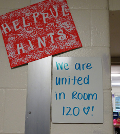 Helpful Hints sign and we are united in room 120 written on a small whiteboard